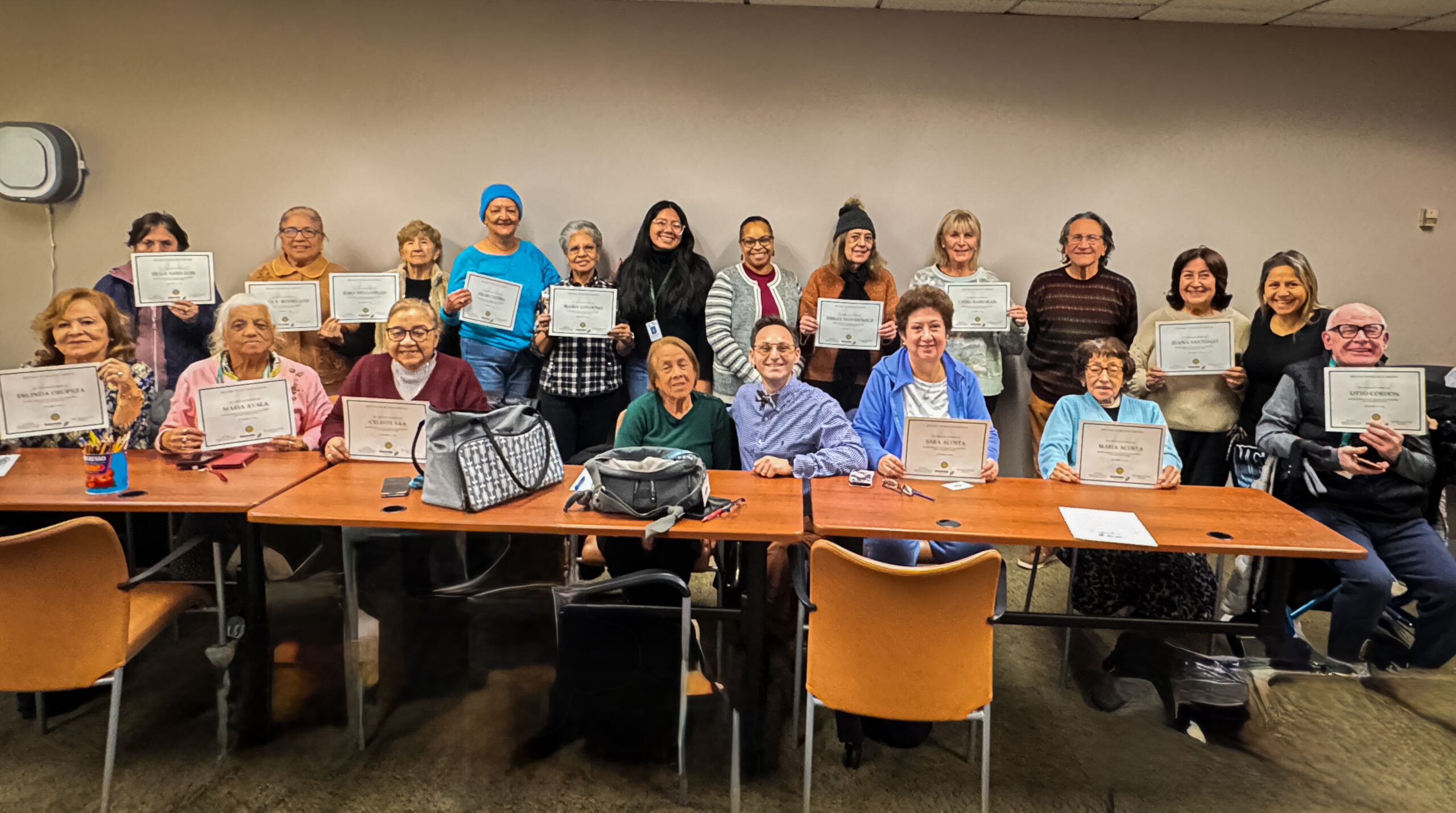 Tech Care You teaching older adults how to use smartphone buttons and touchscreen gestures at the Stamford Senior Center in Stamford Connecticut