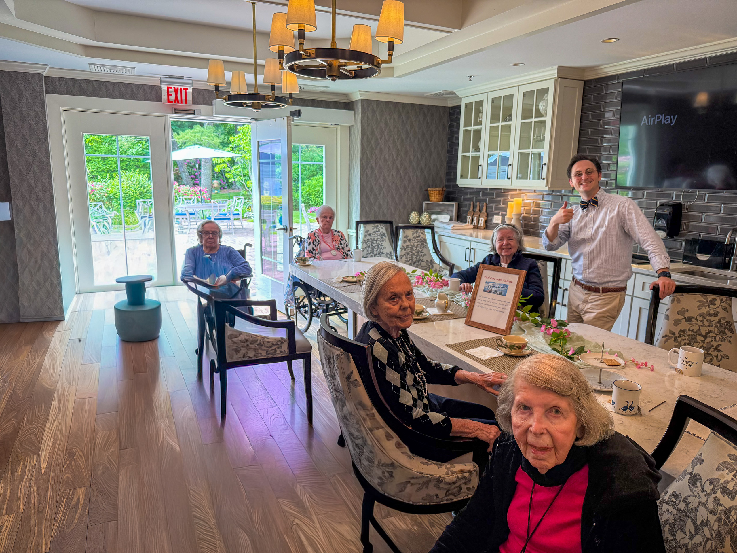 Tech Care You patiently teaching iPhone gestures and smartphone skills to older adults at Maplewood at Darien in Darien Connecticut